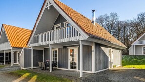 A two-story house with a steeply pitched roof, a balcony, and a chimney. - 4 bedroom lovely home in Gråsten (Gråsten)