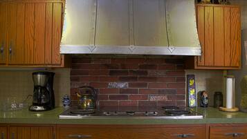 Fridge, microwave, coffee/tea maker, cookware/dishes/utensils