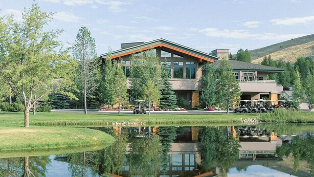 A modern two-story building with large windows and a reflection in the water. - Cute kid-friendly condo next to Dollar Mountain (Sun Valley)