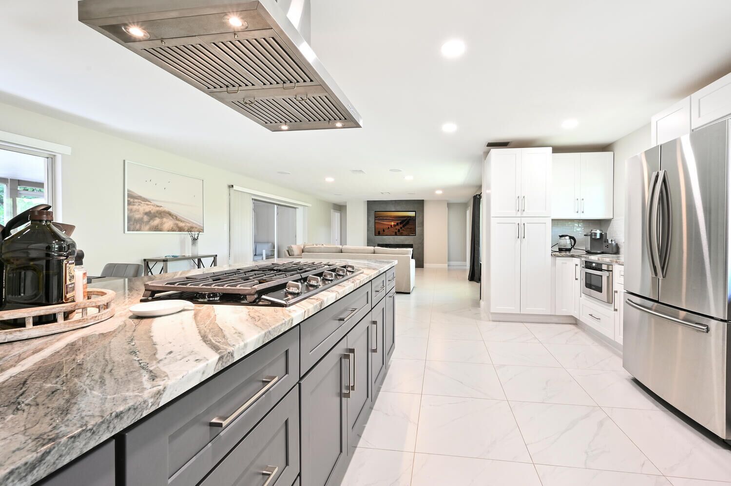 A modern kitchen with a large island, stainless steel appliances, and a sleek design.