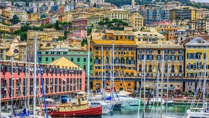 A coastal cityscape with colorful buildings and a marina filled with boats. - Modern and cosy apartment in Genoa, Italy (Genova)