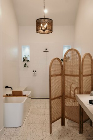 A modern bathroom with a freestanding bathtub, a shower, and a wooden partition. - The Oak & Anchor Hotel (Port Fairy)