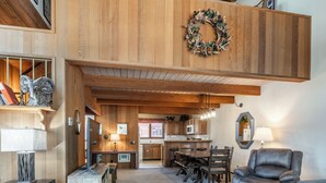 A spacious loft-style living area with a dining table, chairs, and a fireplace. - Spacious Winterset 26 2 Bedrm Plus Loft 3 Full Bathrm Townhome Sleeps 8 Steps to Free Town Shuttle (Mammoth Lakes)