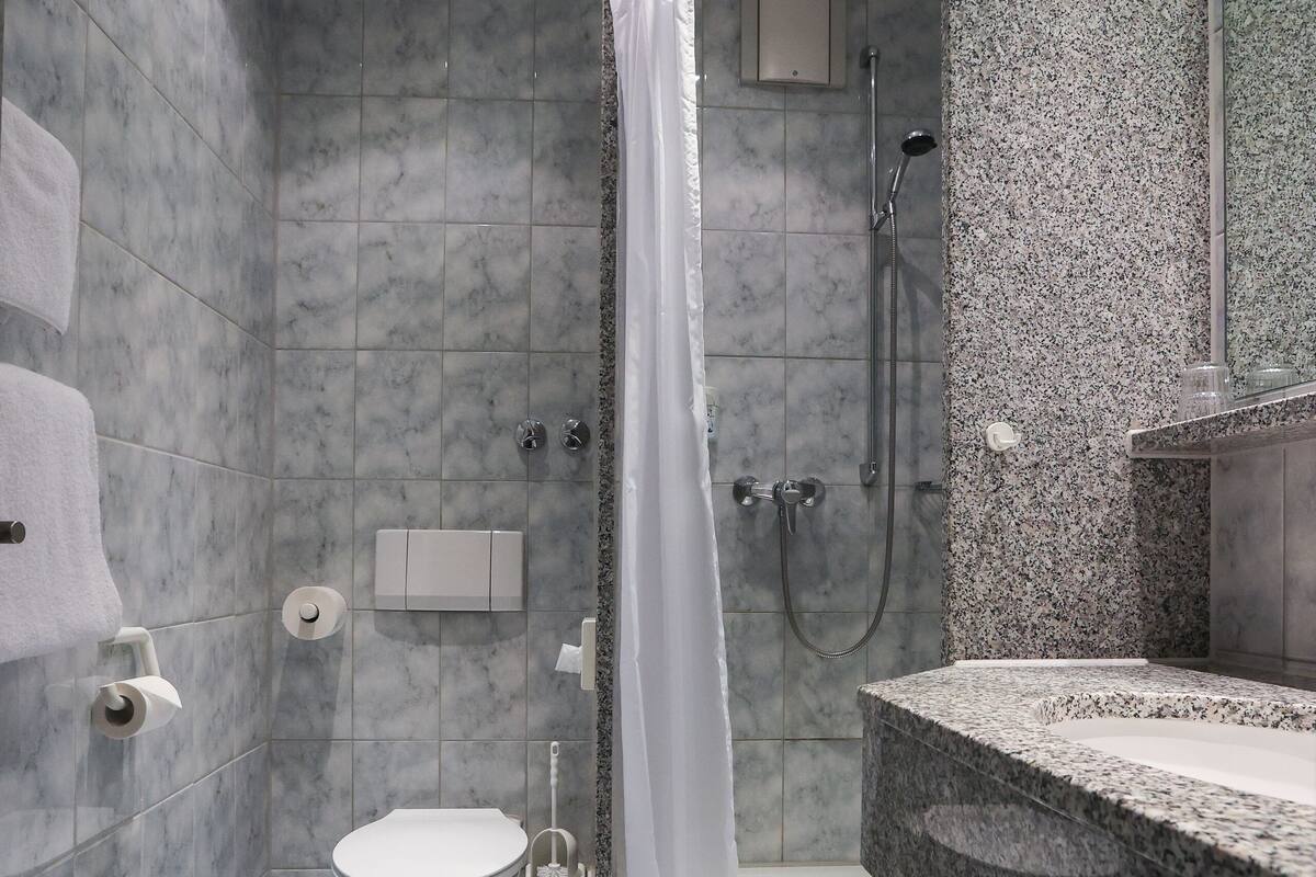 single room | bathroom | shower, hair dryer, towels, soap