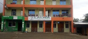 A multi-story building with a sign for Lalwa Safari Lodge. - Lalwa Safari Lodge (Kabarnet)