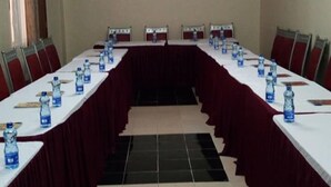 A conference room with a long table, chairs, and water bottles. - Lalwa Safari Lodge (Kabarnet)