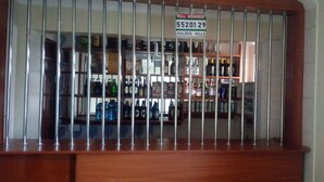A bar area with a metal railing and a sign indicating the Till Number 55201 29. - Lalwa Safari Lodge (Kabarnet)