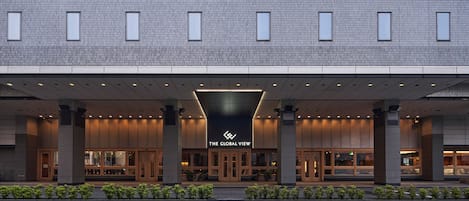 A modern hotel entrance with a prominent sign reading "The Global View."