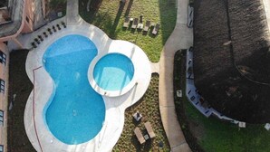 A rooftop pool area with two pools, surrounded by a walking path and seating areas. - Hunters Paradise Cottages (Bungoma)