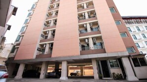 A multi-story residential building with balconies, a covered parking area, and a gated entrance. - Meesook Residence (Nonthaburi)