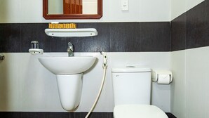 A bathroom with a sink, toilet, and mirror. - Khanh Vy Hotel (Ho Chi Minh City)