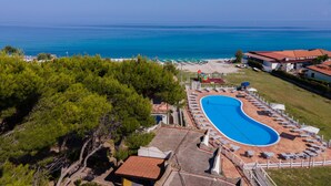 A resort with a large swimming pool, beach area, and ocean view. - Residence Emmesse Trilocal 3 Rooms (Zambrone)