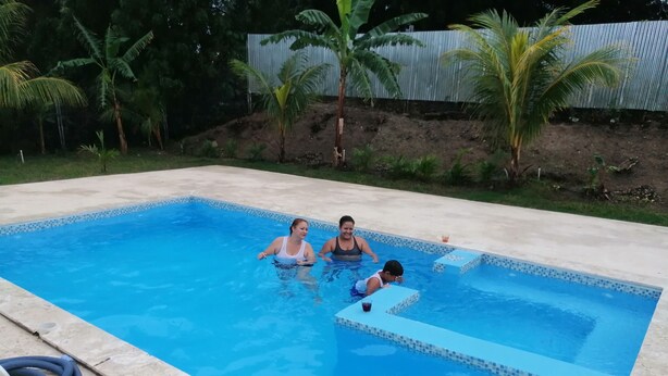 Una piscina rectangular con borde de azulejos, rodeada por una plataforma de hormigón.