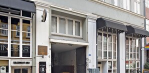 A building with a 'Basement Bar' sign, large windows, and a number '26' on the wall. - City 2- Cosy 1 Bdr Apt In the Center of Copenhagen (Copenhagen)
