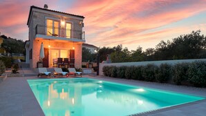 A two-story stone house with a swimming pool, outdoor seating, and a view of the surrounding landscape. - Sun Spalato Villa Cikas (Murter-Kornati)