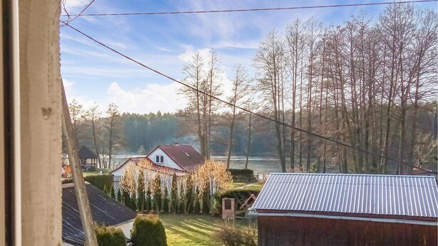 A rural landscape with a house, a wooden shed, and a field. - 4 bedroom amazing home in Parzensko (Parzensko)
