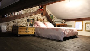 A bedroom with a wooden bed, a dresser, and a sloped ceiling. - In the heart of a preserved, welcoming, flower-filled mountain village (La Fajolle)