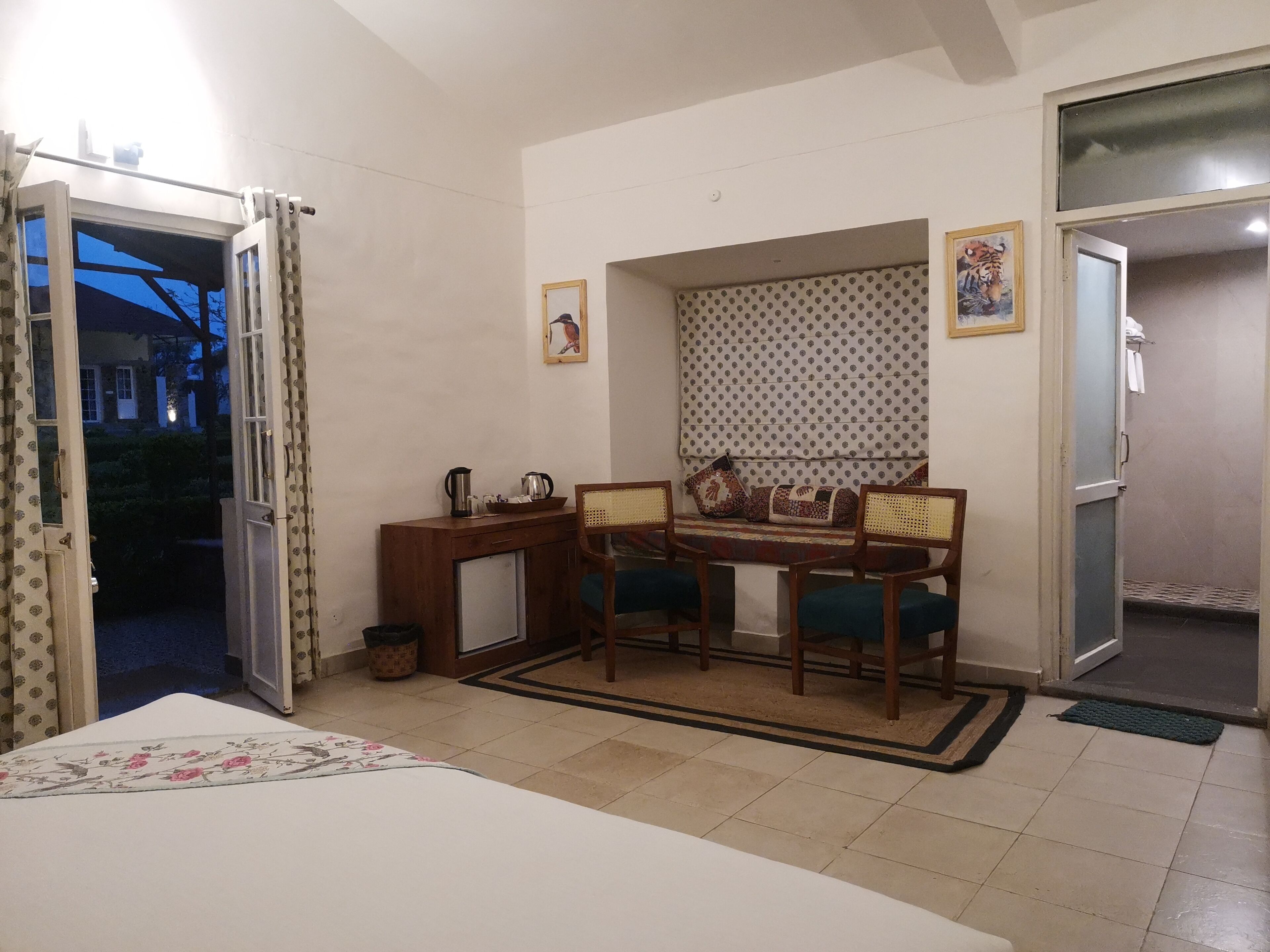 A compact living space with a dining area, a small kitchenette, and a bedroom.