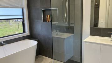 Bathtub, towels, soap, toilet paper