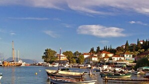 A coastal town with boats docked at the harbor, buildings with red roofs, and a clear sky. - Beautiful Modern Apartment in Lefkada, Greece (Lefkada)