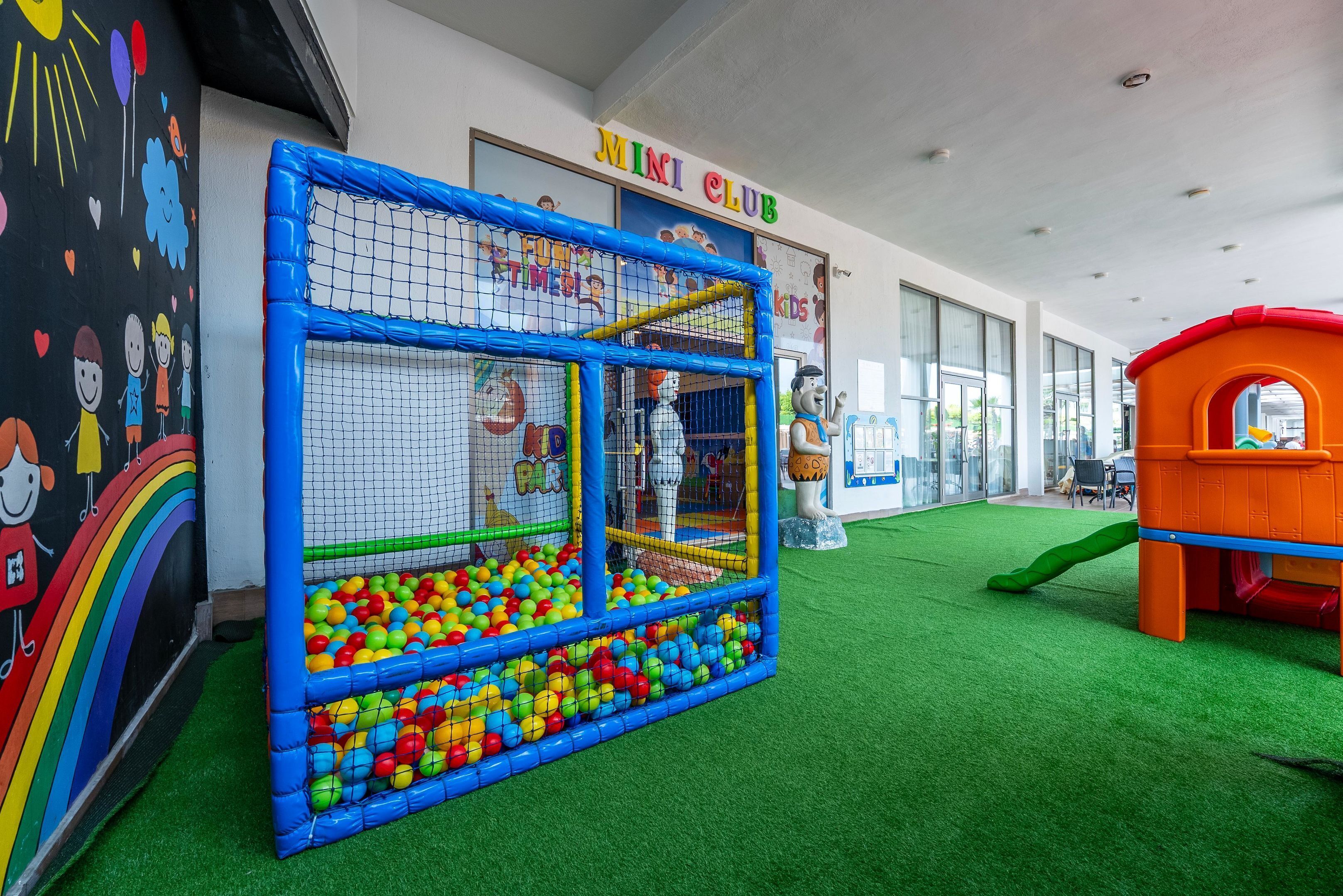 A children's play area with a ball pit and a climbing net, labeled "MINI CLUB".