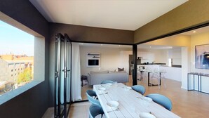 A modern apartment with a dining area, kitchen, and living space. - MINT Apartments Greenside (Randburg)