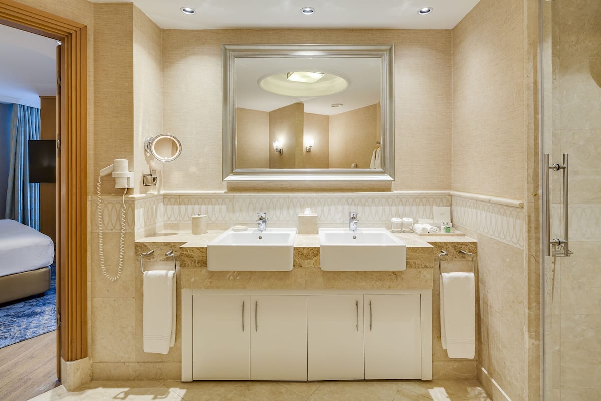 separate bathtub and shower, hair dryer, slippers, towels