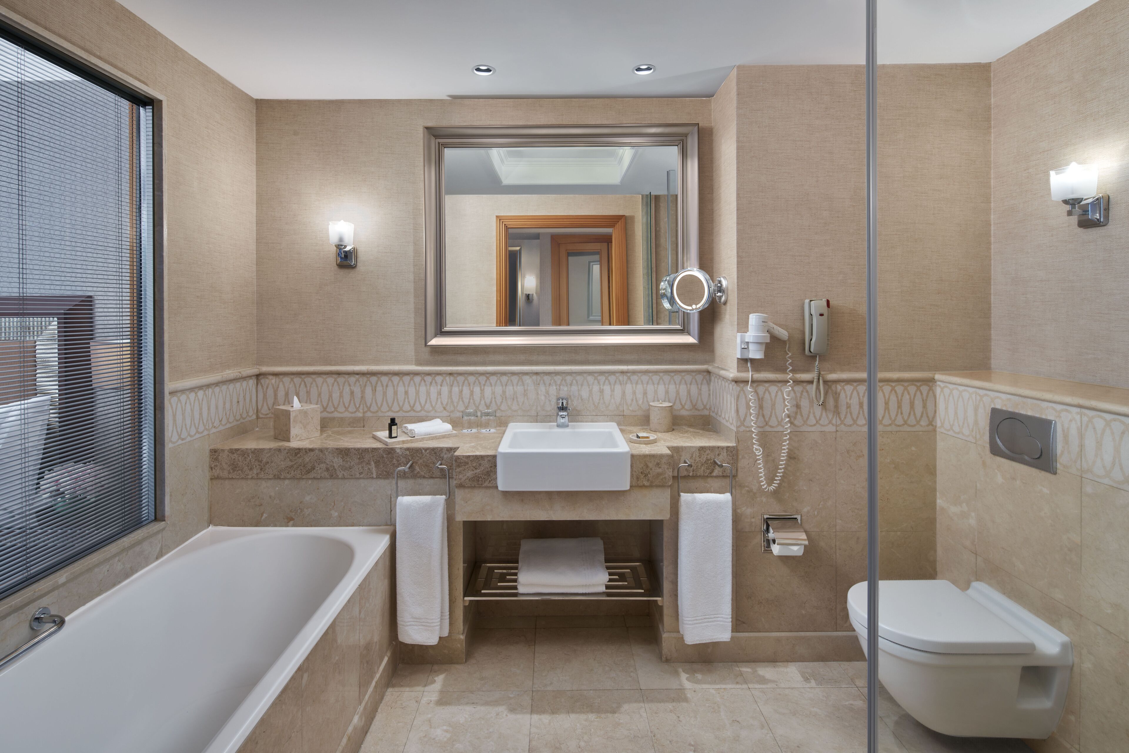 separate bathtub and shower, hair dryer, slippers, towels