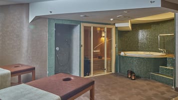 A modern bathroom with a glass shower enclosure, a freestanding bathtub, and a wooden bench.