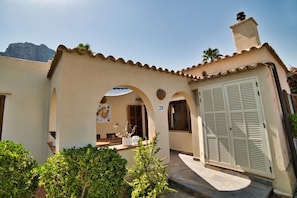 A Mediterranean-style building with a tiled roof, arched doorways, and a number '29' sign. - Casa Abeja - mountain and sea views / saltwater pool 5 min to the sea / mountains (Betlem)