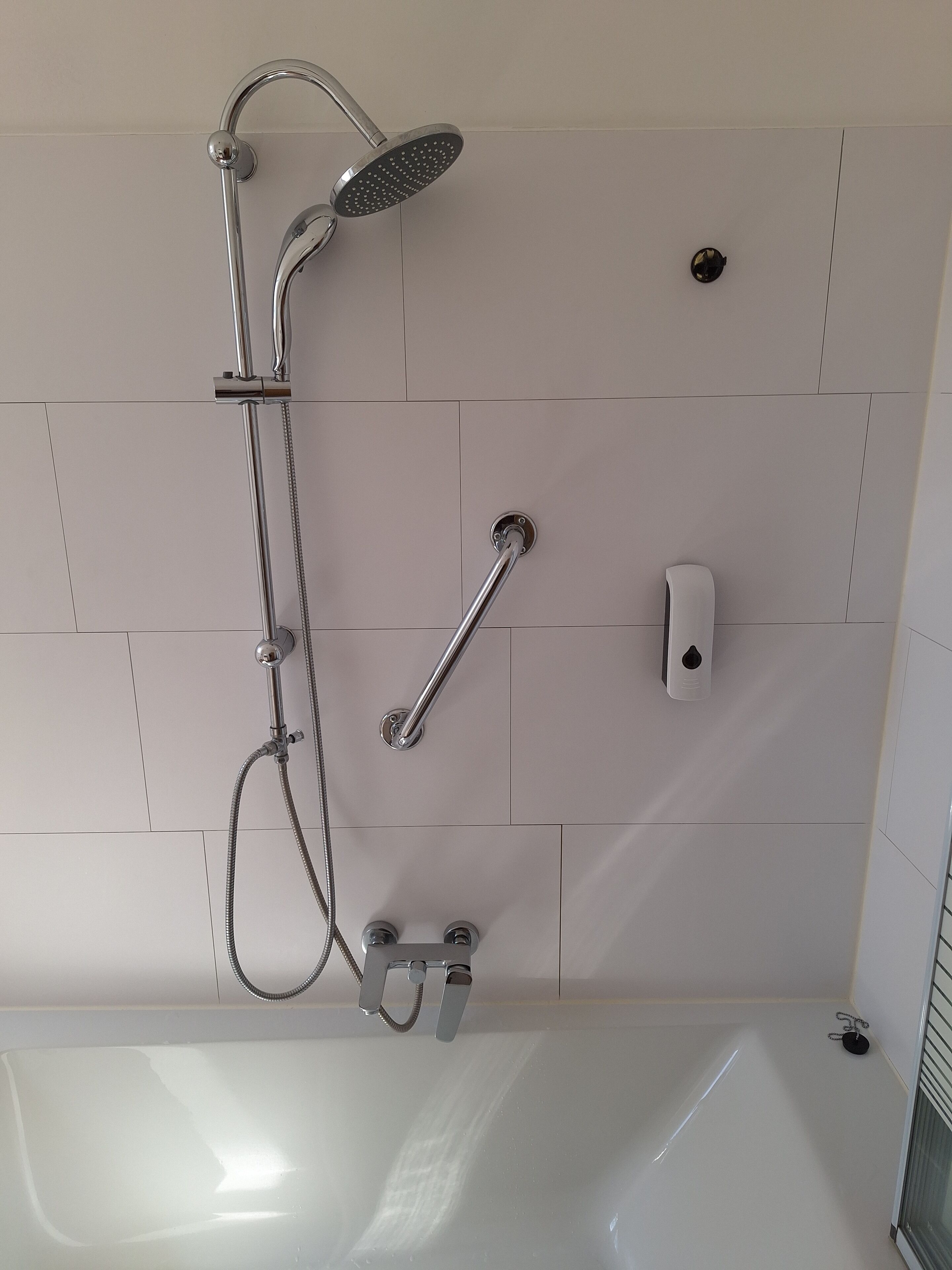 Bathtub, towels, soap, toilet paper