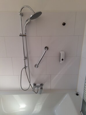 Bathtub, towels, soap, toilet paper
