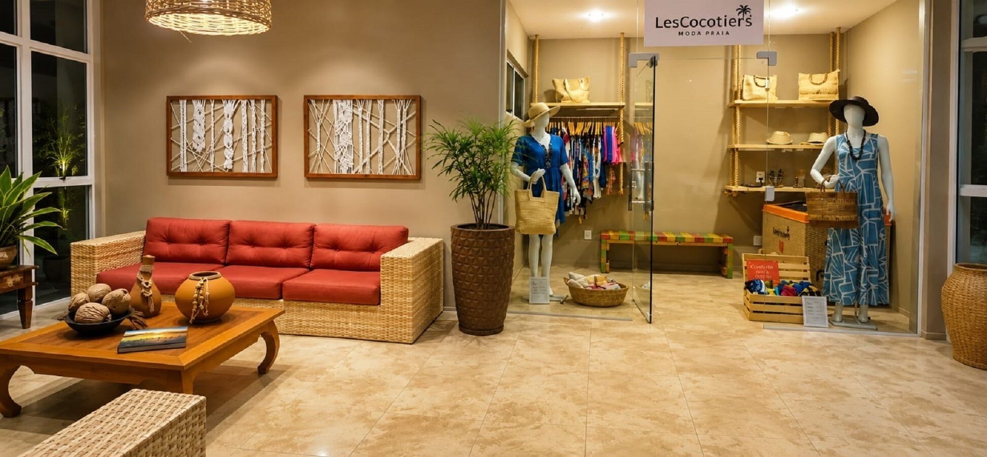 A hotel lobby with a red sofa, wicker furniture, a potted plant, and a mannequin displaying clothing.