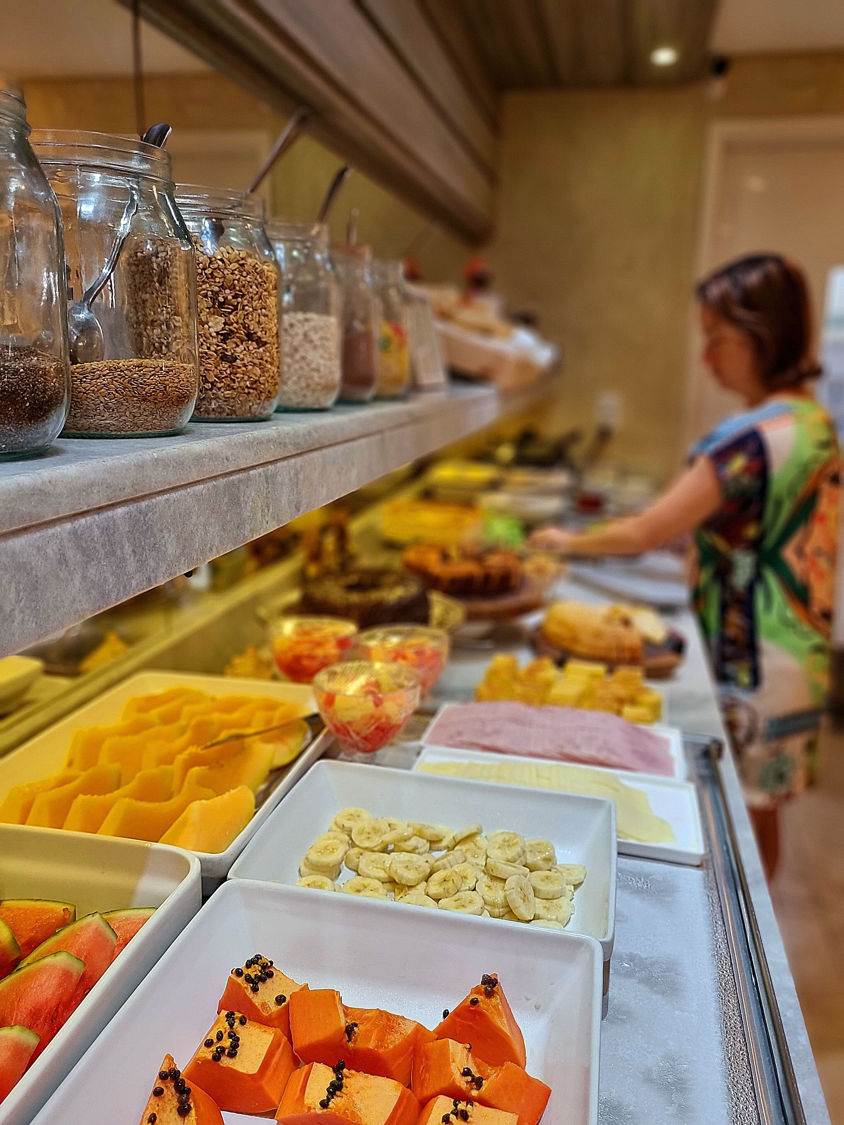 A buffet with various food items and condiments.