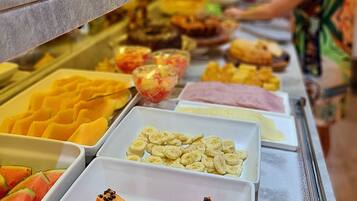 A buffet with various food items and condiments.