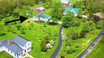 A large estate with multiple buildings, a winding driveway, and well-maintained lawns.