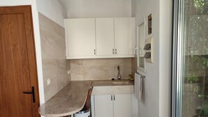 A compact kitchen with white cabinets, a granite countertop, and a stainless steel trash bin. - CHARMING VILLA WITH PRIVATE POOL - Special Summer 2026 Discount (Allauch)