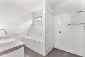 Bathtub, hair dryer, towels, shampoo
