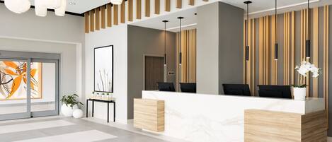 A modern reception area with a marble counter, wooden accents, and contemporary lighting fixtures.