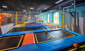 An indoor trampoline area with safety nets and padded surfaces. - Aminess Vival Casa Lisanj (Delnice)