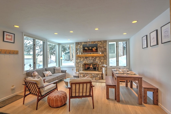 Comfortable, stylish living room with gas fireplace and dining table
