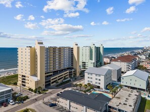 A coastal hotel with multiple floors, a parking garage, and a view of the ocean. - Direct Oceanfront 3 Bed/3 Bath Condo in Cherry Grove (North Myrtle Beach)