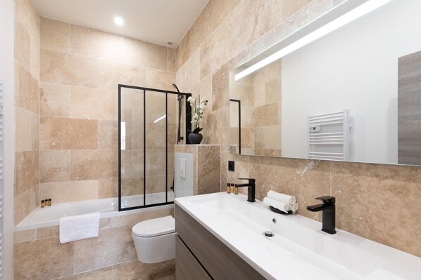 Bathtub, hair dryer, towels, soap