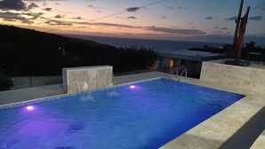A rectangular swimming pool with a tiled edge and a marble surround. - Private Villa, Ocean & Mountain view with Solar Heated Pool. (Quebradillas)