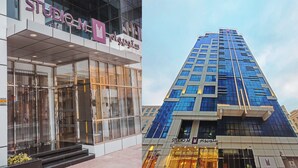 A modern building with a glass facade and a sign reading "STUDIO M".