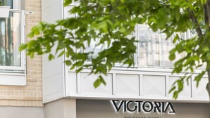 A building with a sign that reads "Victoria Boutique Hotel."