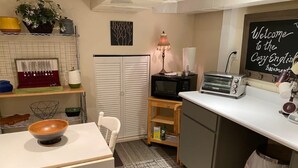 A compact kitchen with a microwave, toaster, and a chalkboard sign. - Cozy English Basement Apt quiet but close to downtown (Winchester)