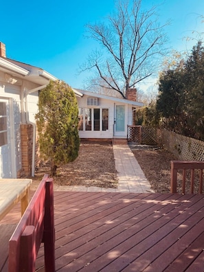 A residential property with a patio, a small garden, and a detached garage.