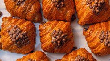 Une collection de croissants dorés et bruns, disposés sur une surface.