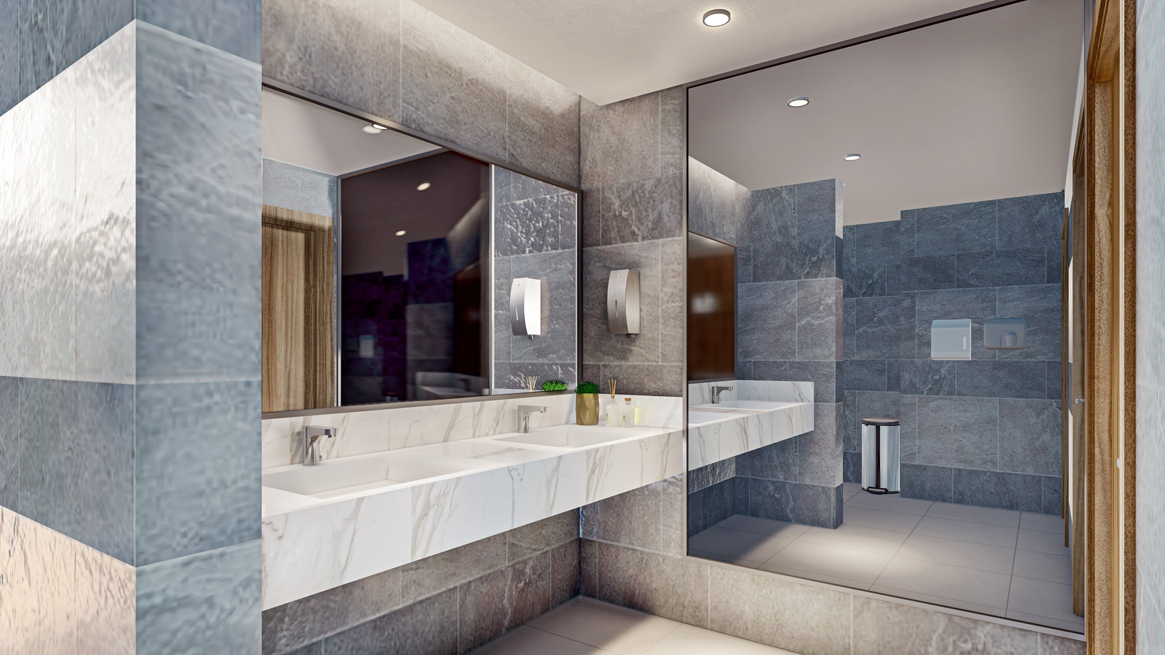 Un baño moderno con tocador de mármol, un espejo grande y una cabina de ducha de vidrio.